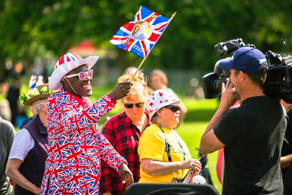 Black man holding British Flag during the royal wedding
